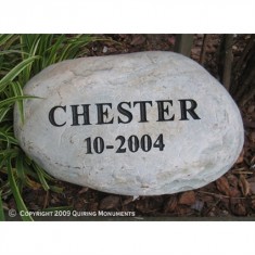 A simple memorial for Chester, engraved on river rock.